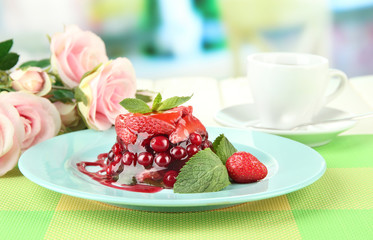 Tasty jelly dessert with fresh berries, on bright background