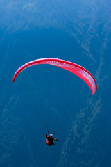 Red paraglide over Alps peaks