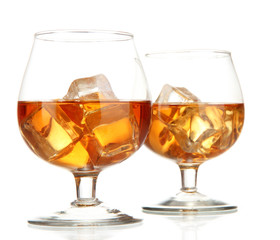 Brandy glasses with ice isolated on white