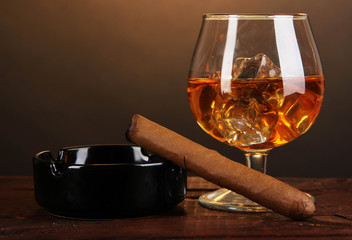Brandy glass with ice and cigar