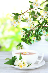 Cup of tea with jasmine, on bright background