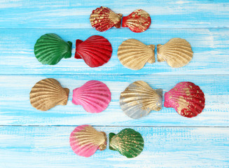 Colorful seashells on color wooden background