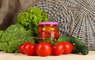 Fresh vegetables and canned on wooden table close up