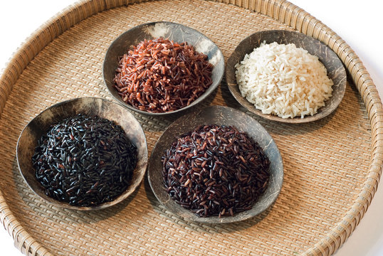 4 bowls of raw rice; brown, red, black, and black sweet rice
