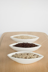 3 bowls of raw rice; brown, red, and mixed rice