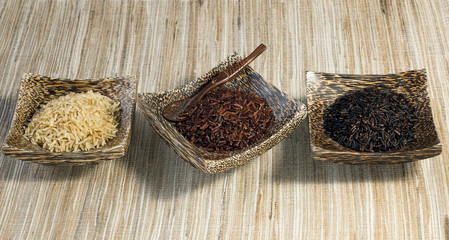 3 bowls of raw rice; brown, red, black rice