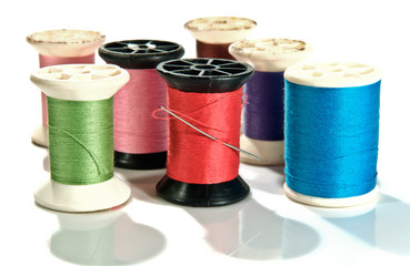 old Spool of thread and needle