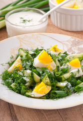 Salad of boiled eggs, green onions and cucumber 