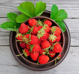 Strawberries on a bowl in the summer garden