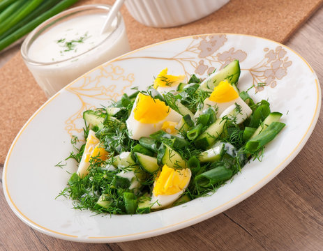 Salad of boiled eggs, green onions and cucumber 