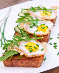 toast with fried egg, cucumber and arugula
