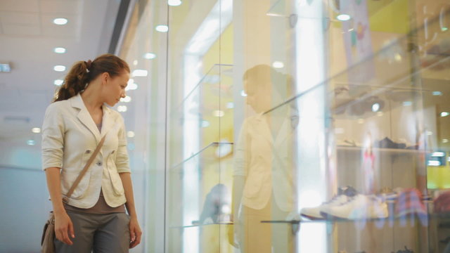 young, pretty business woman chooses clothes in shop