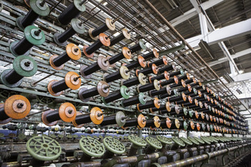 Large group of bobbin thread cones on machine