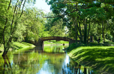 Beautiful park landscape with river and bridge