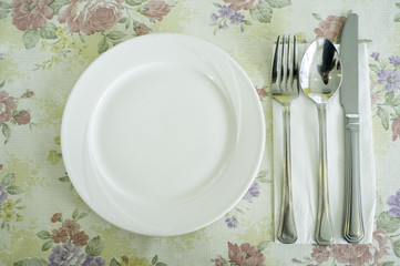 Dish, spoon, knife and fork on lovely tablecloth