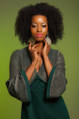 Sensual retro seventies fashion afro woman with green dress. Gre
