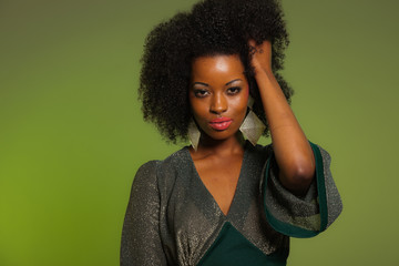 Sensual retro seventies fashion afro woman with green dress. Gre