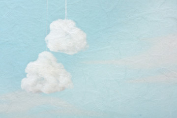 Two cotton wool cloud against blue background.