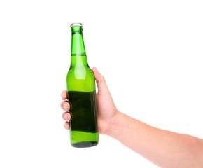 A hand holding up a green beer bottle