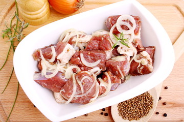 Lamb marinated with onion, spices and herbs in bowl