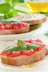 Bruschetta with tomato, basil and olive oil.