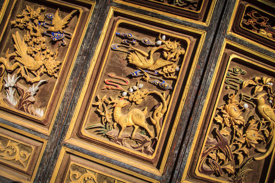 Animals carved into wooden door at temple