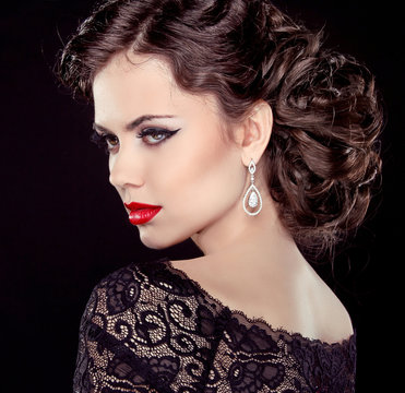 Fashion Brunette Model Portrait. Jewelry and Hairstyle. Elegant