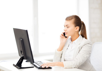 businesswoman with smartphone in office