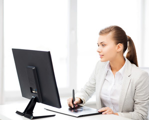 businesswoman with drawing tablet in office