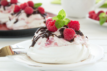 Meringue with raspberry cream, raspberry and chocolate.
