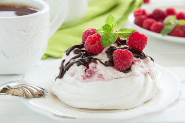 Meringue with raspberry cream, raspberry and chocolate.