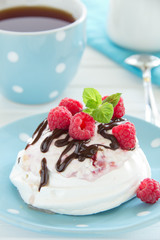 Meringue with raspberry cream, raspberry and chocolate.