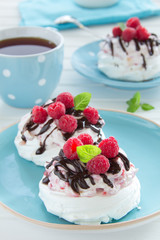 Meringue with raspberry cream, raspberry and chocolate.