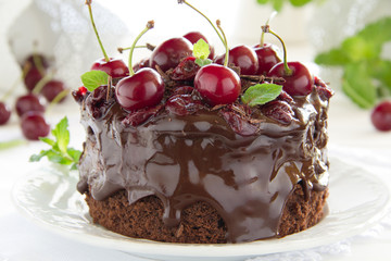 Chocolate cake with cherries and chocolate cream.