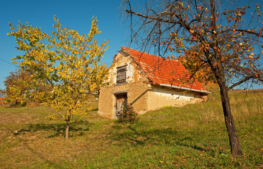 Naklejka na ściany i meble Rural house in autumn