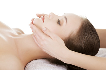 Obraz na płótnie Canvas Relaxed woman enjoy receiving face massage at spa saloon