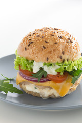 Burger with meat and vegetables.