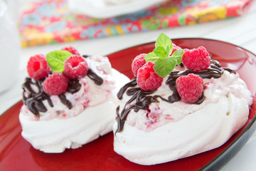 Meringue with raspberry cream, raspberry and chocolate.