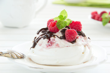 Meringue with raspberry cream, raspberry and chocolate.