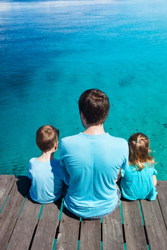 Father and kids enjoying ocean view