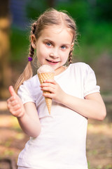 Happy cute child eating ice cream