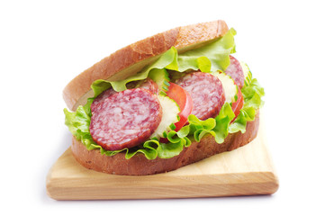 Sandwich with sausage, cucumber and tomato