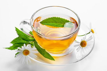 Cup with green tea and green leaves.