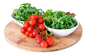 bowl of fresh green, natural arugula and cherry tomatoes