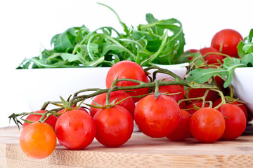 bowl of fresh green, natural arugula and cherry tomatoes