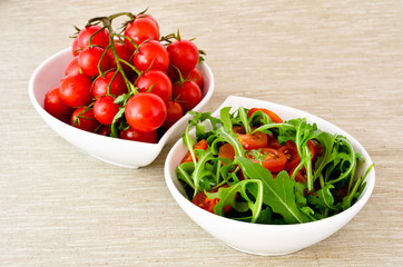 bowl of fresh green, natural arugula and cherry tomatoes