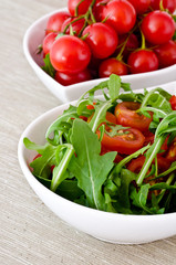 bowl of fresh green, natural arugula and cherry tomatoes
