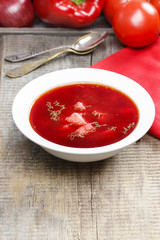 Traditional beetroot soup on old wooden table
