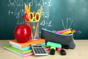 Back to school - blackboard with pencil-box and school