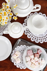 Table setting with chamomiles on wooden table